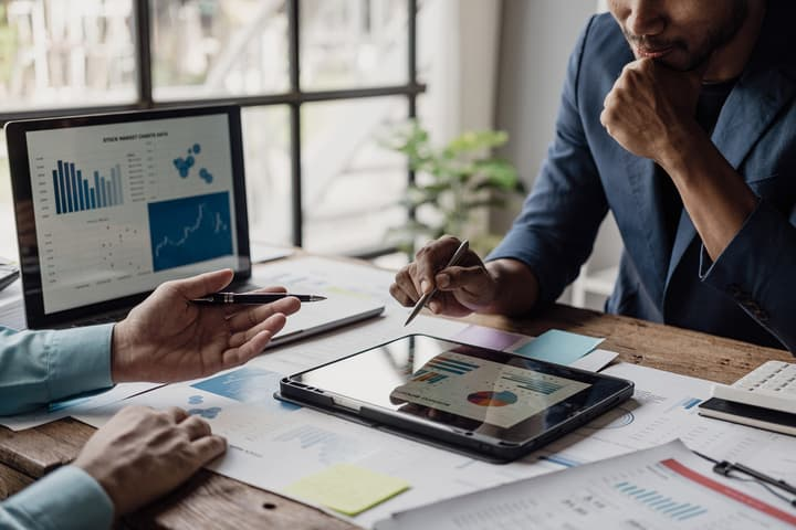 Advisors reviewing market charts and financial data
